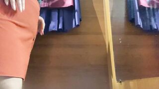 Curvy mom into the mall fitting room trying on skirts
