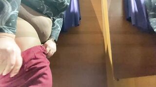 Curvy mom into the mall fitting room trying on skirts