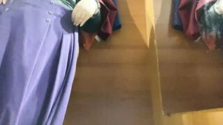 Curvy mom into the mall fitting room trying on skirts