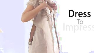 Luscious blonde Dido Angel inspects herself in the mirror as she tries on dresses that show off her tanned toned