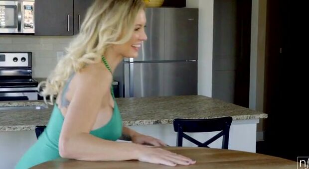 Kenzie Taylor is celebrating St. Patty's Day with a green dress and green beads. The