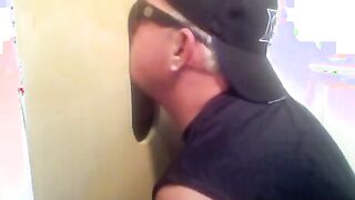 Two hot visitors take turns for a hot glory hole blowjob