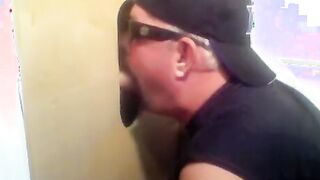 Two hot visitors take turns for a hot glory hole blowjob