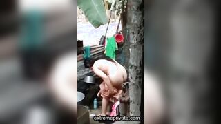an outdoor wash of a rural Indian mom