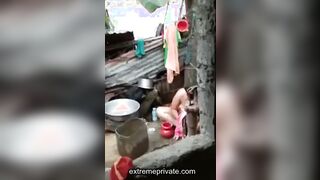 an outdoor wash of a rural Indian mom