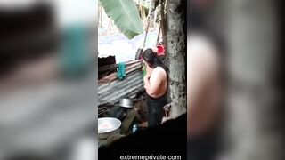 an outdoor wash of a rural Indian mom