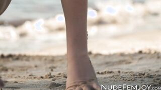 Exotic cutie Natalia playing on a sandy beach
