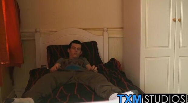 The handsome twink is relaxing on the bed and wanking off