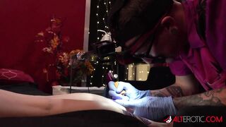 Big Boobed tattooed blonde gets a new tattoo and 2 long cocks