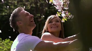 Angel Piaff and Lutro enjoy a sweet moment outdoor beneath the blossoms of a cherry tree. Their laughter turns to