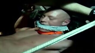 Muscle jock tied up with fat rope during outdoor BDSM