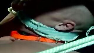 Muscle jock tied up with fat rope during outdoor BDSM