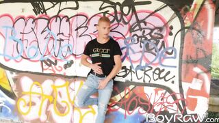 Young guy masturbates in public in front of graffiti wall