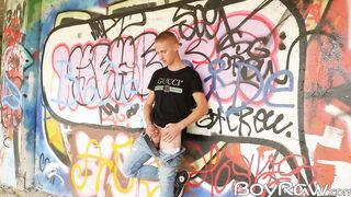 Young guy masturbates in public in front of graffiti wall