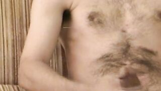 Hairy young guy tugs raging dick and cums all over the place