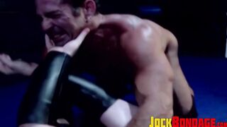 Tattooed wrestler tied up and dominated by his opponent