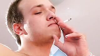 Sexy young gay man having a smoke while getting rammed