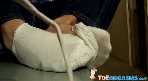 Young foot lover Clyde strokes his cock and cums on his feet