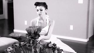 Bombshell 50s housewife Maya Woulfe puts on a record as she waits for her husband, Nathan Bronson, to come home.
