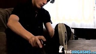 Skinny twink massages his feet and strokes massive dick