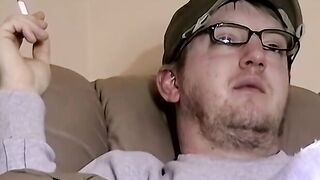 Cute amateur Jack with glasses masturbates on a leather sofa