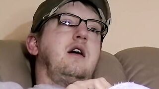 Cute amateur Jack with glasses masturbates on a leather sofa