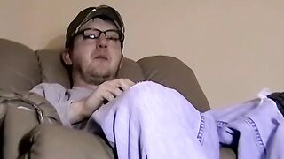 Cute amateur Jack with glasses masturbates on a leather sofa