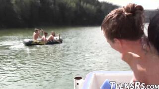 Group of naughty teens is having fun while swimming outdoor