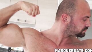 Muscular gay hunk playing with his big curved cock
