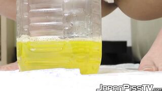 Japanese cutie removes her pants to fill the bottle with piss