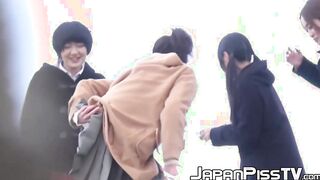 Four Japanese schoolgirls fool around outside before peeing