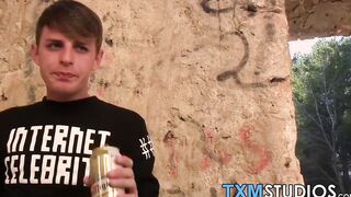 Blond twink fed with two dicks out in the open
