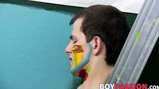 Colorful twink gets feet painted in blowjob induced cum