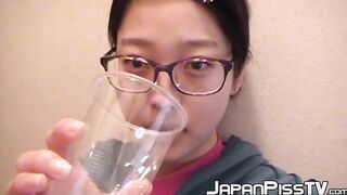 Adorable Japanese chick sits on the toilet and pees in a cup