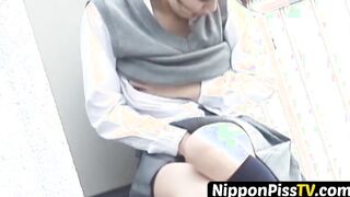 Japanese chick rubs herself outside before furtively peeing