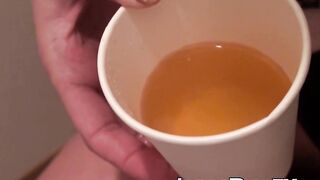 Japanese cutie fills a cup up with her pee and records it