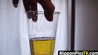 Delightful Japanese chick sits on the latrine and pees in a cup