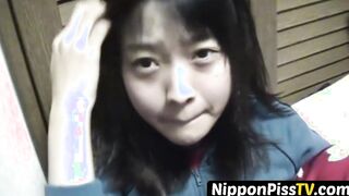 Delightful Japanese chick sits on the latrine and pees in a cup