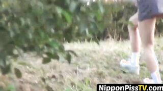 Entrancing Japanese young lady peeing rapidly outside during day