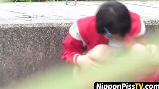 Short haired Japanese darling in tracksuit pees in the road