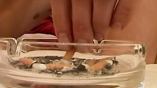 Smoking twink enjoys watersports play while stroking cock