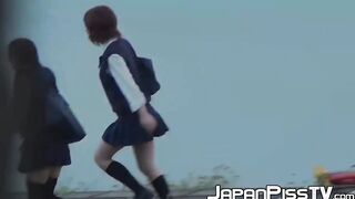 Three Japanese schoolgirls pissing hard together in public