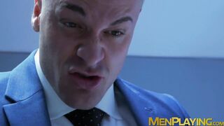 Muscular executive in a suit stuffing his cute buff employee