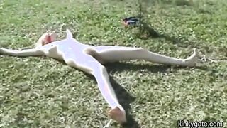 My blonde slut lying tied up on the lawn