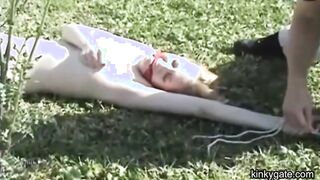 My blonde slut lying tied up on the lawn