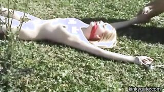 My blonde slut lying tied up on the lawn