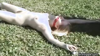 My blonde slut lying tied up on the lawn