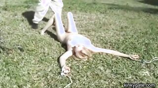 My blonde slut lying tied up on the lawn