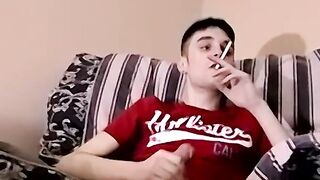 Hot and sexy guy smokes while masturbating
