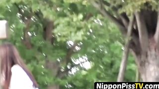 Tempting Japanese in skirt peeing behind seat in park